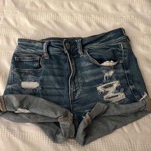 Dark blue, ripped, jean shorts. American Eagle.